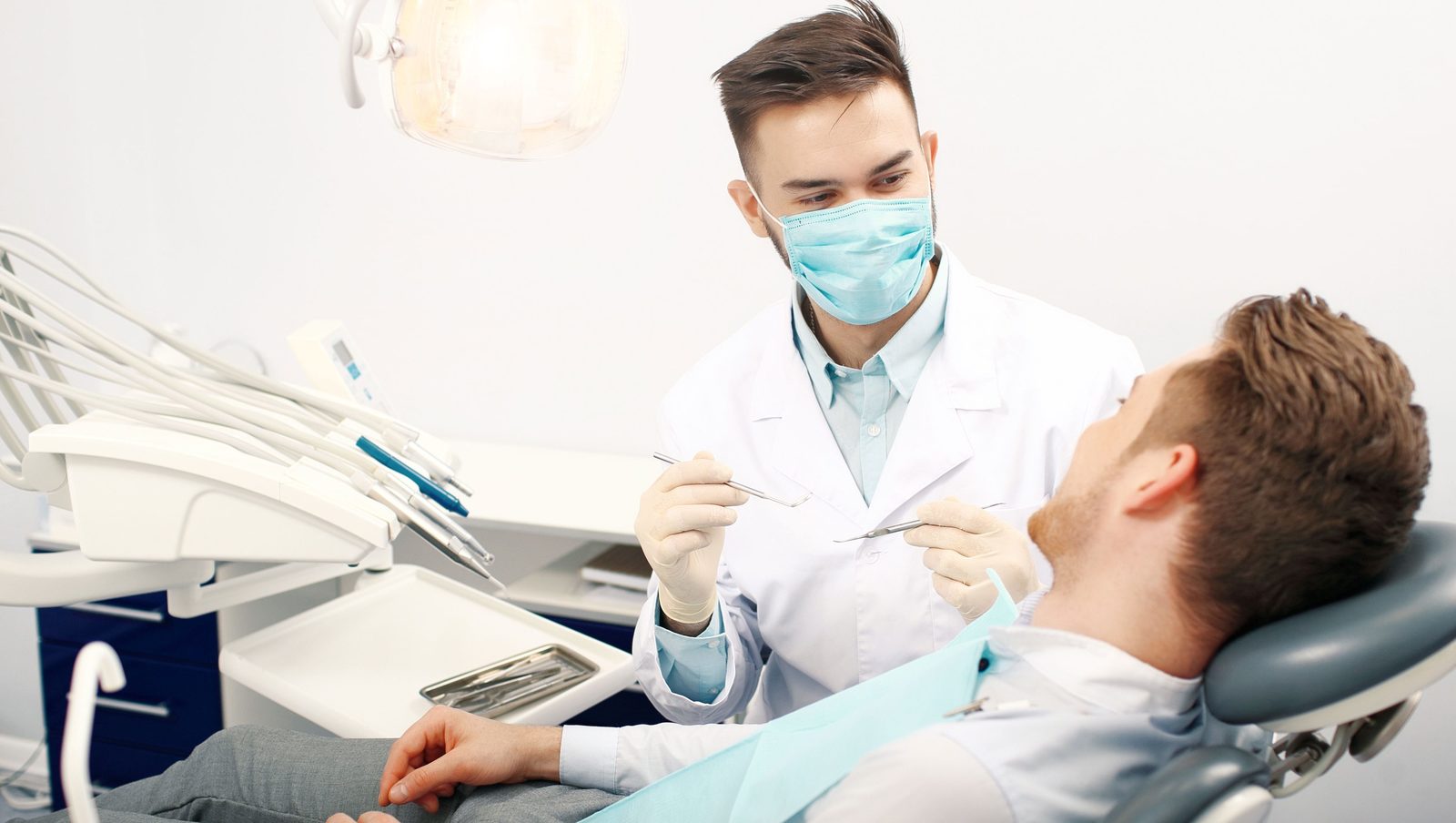 Dentist examining a patient in a BrightPath treatment room