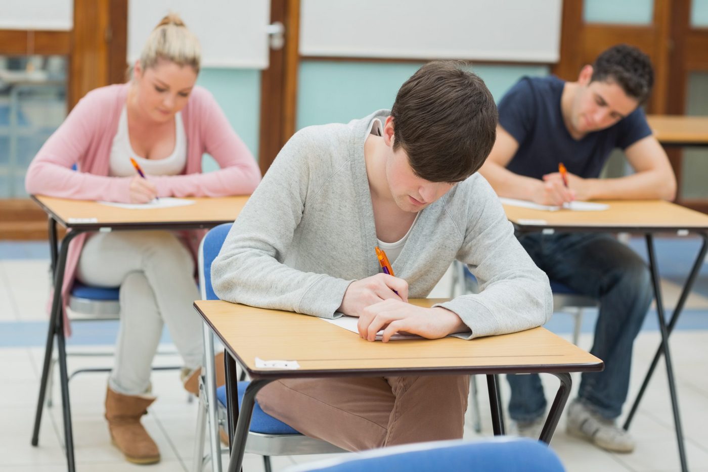Students writing a practice test in a classroom