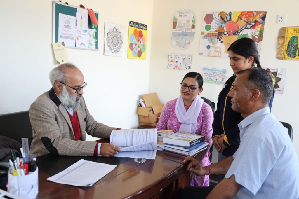 Counsellor reviewing documents with a student and family