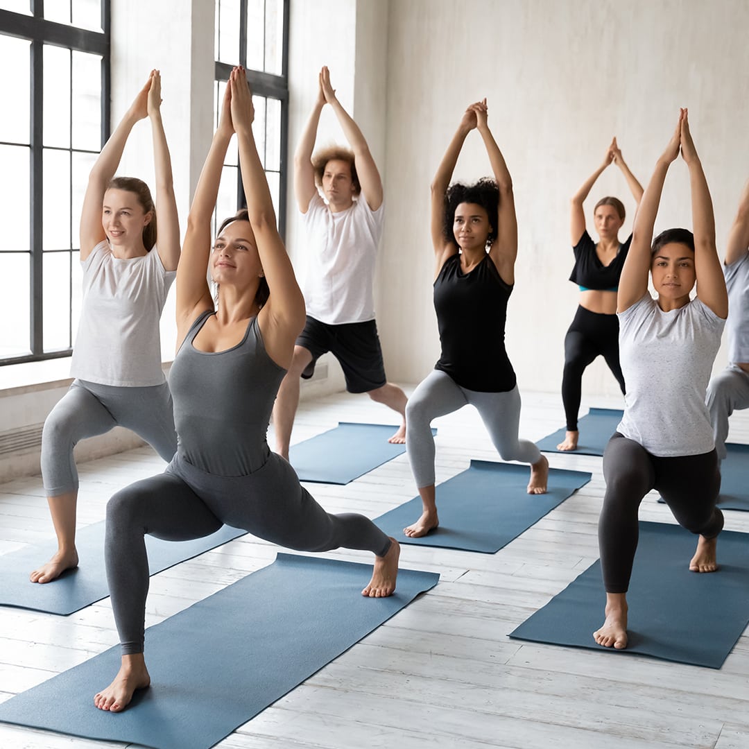 Yoga instructor in a seated meditation pose during class