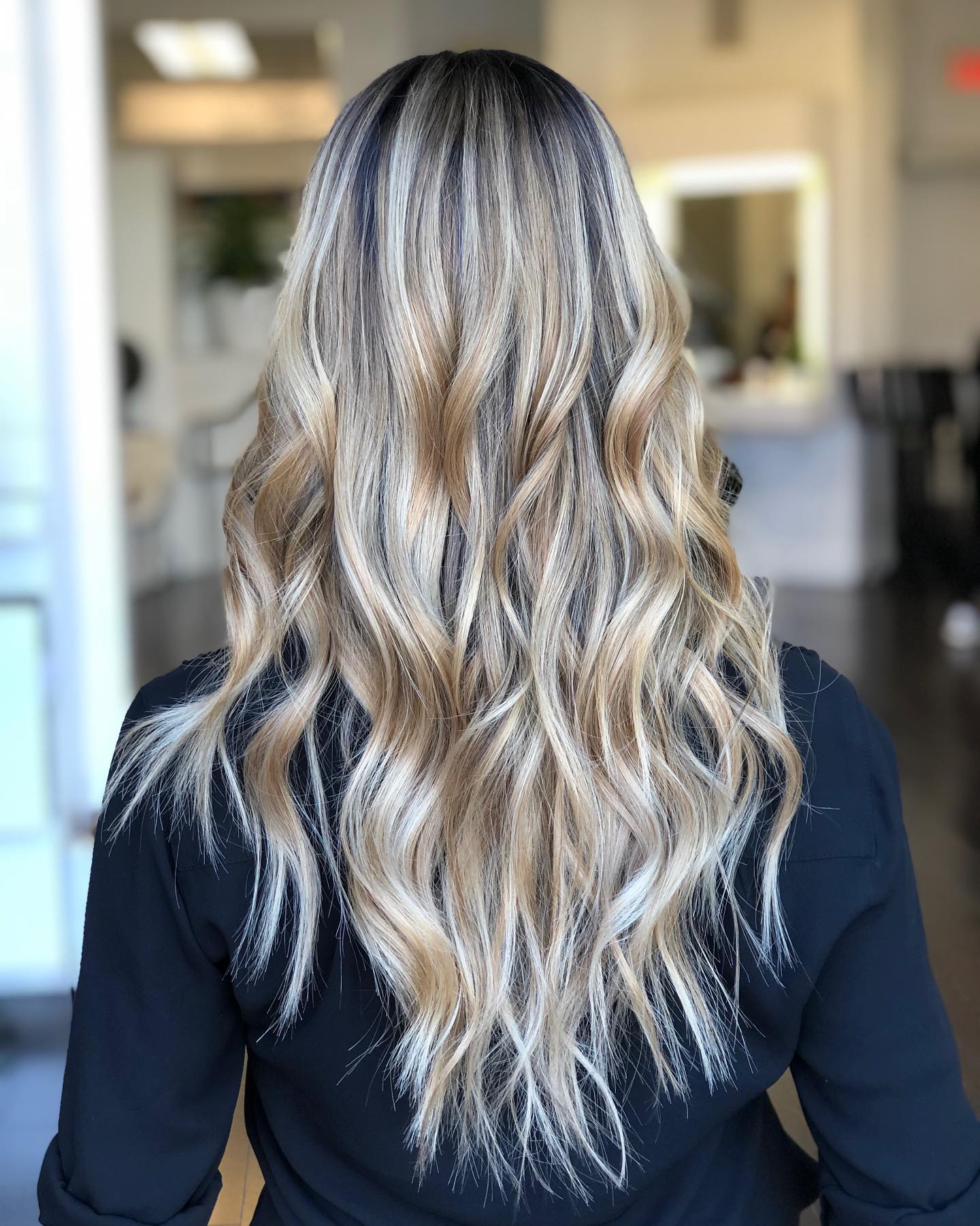 Dimensional blonde balayage with soft waves